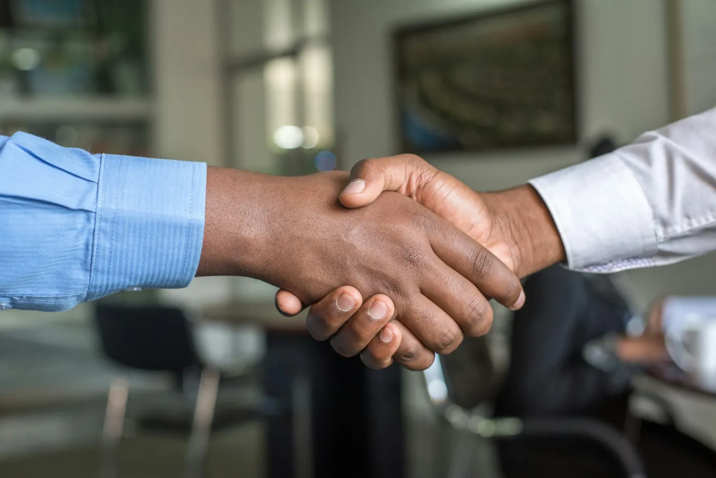 A business owner and advisor shaking hands over a key-person cover agreement